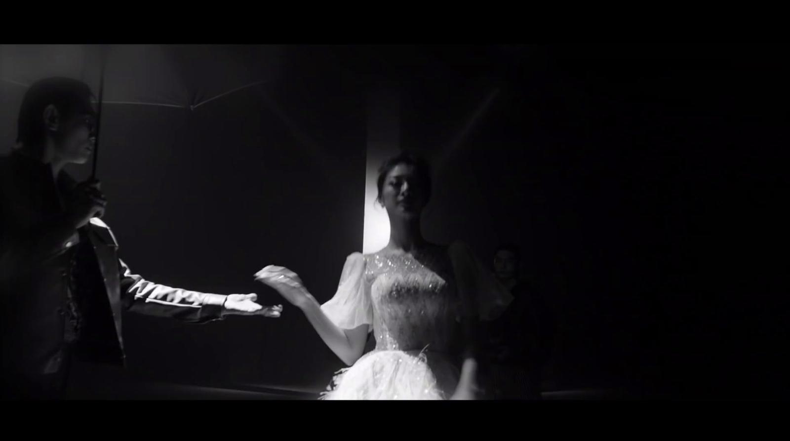 a man standing next to a woman in a white dress