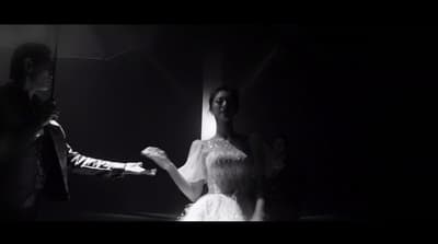 a man standing next to a woman in a white dress