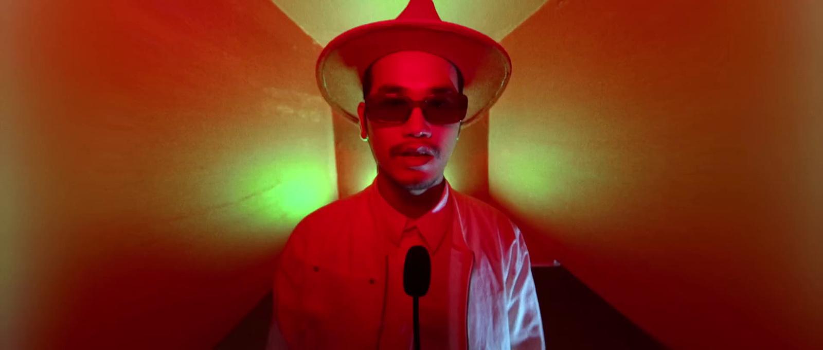 a man wearing a red hat and a microphone