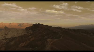 a view of a mountain range at sunset