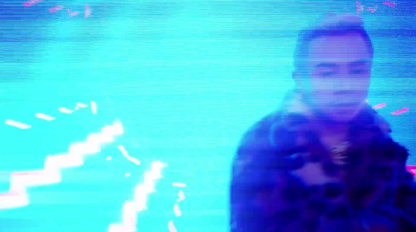 a blurry photo of a man holding a cell phone