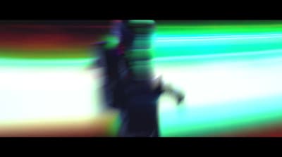 a blurry image of a person walking down a street