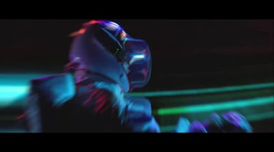 a man in a futuristic suit is dancing in the dark