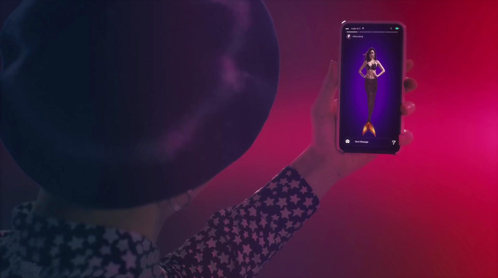 a woman holding up a cell phone in front of her face