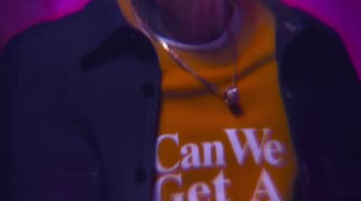 a man wearing a t - shirt that says can we get a beer?
