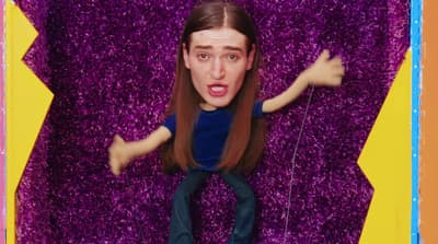 a cardboard cut out of a man with long hair
