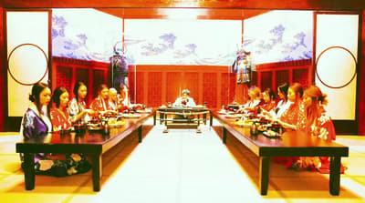 a group of women sitting at a long table