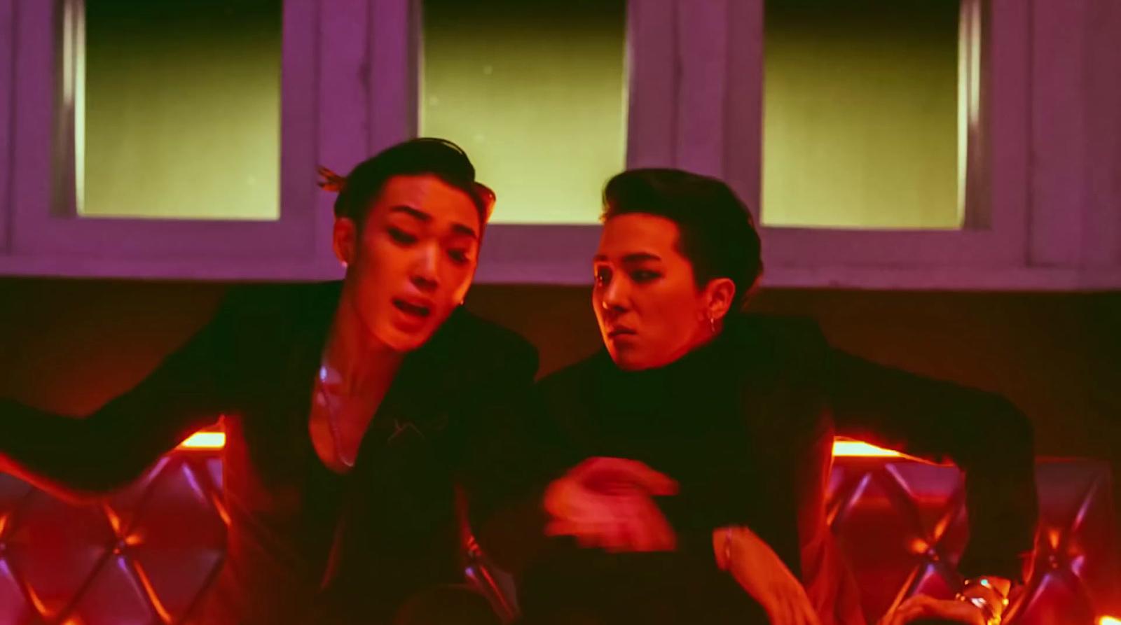 a couple of men sitting next to each other