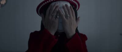 a woman covering her face with her hands