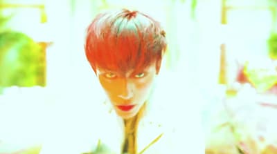 a person with red hair and a white shirt
