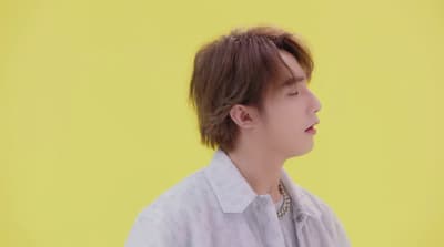 a man in a white shirt and a yellow background