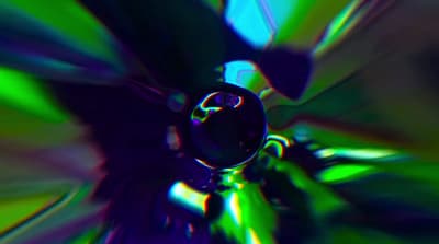 a blurry image of a green and blue flower