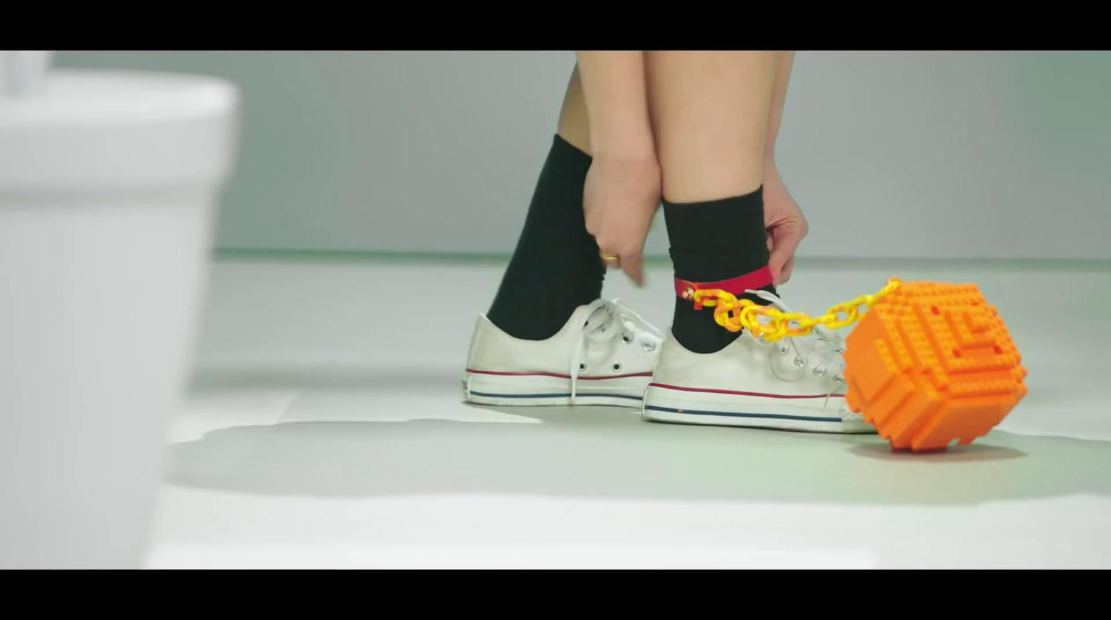 a person tying a shoelace to a pair of tennis shoes
