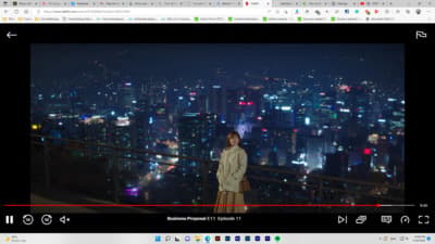 a woman standing on top of a tall building