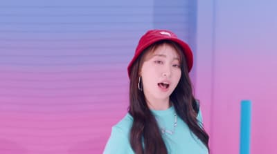 a girl with long hair wearing a red hat