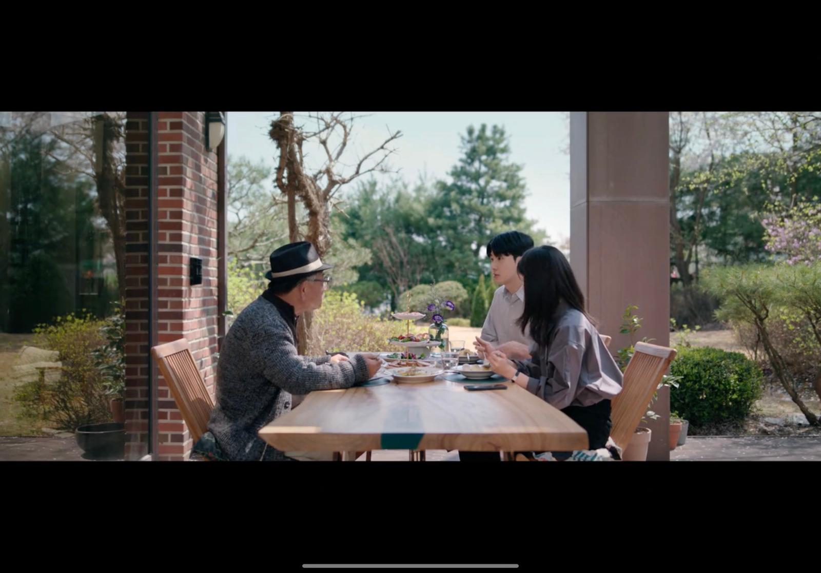a couple of people sitting at a wooden table