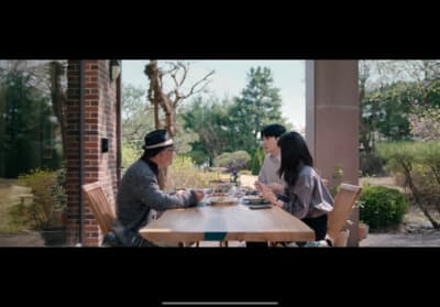 a couple of people sitting at a wooden table