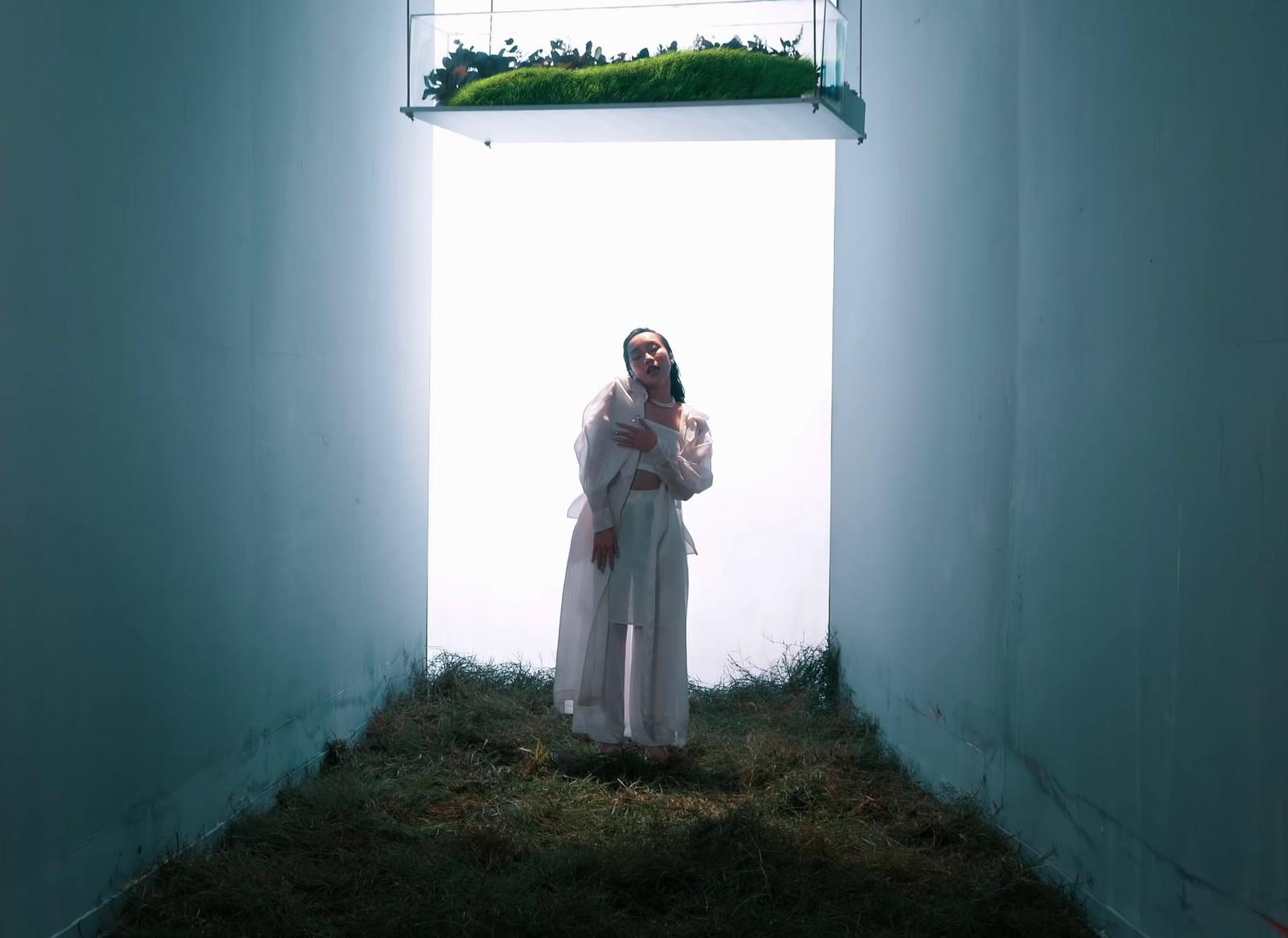a woman in a white robe standing in a room