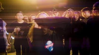 a group of people standing around each other