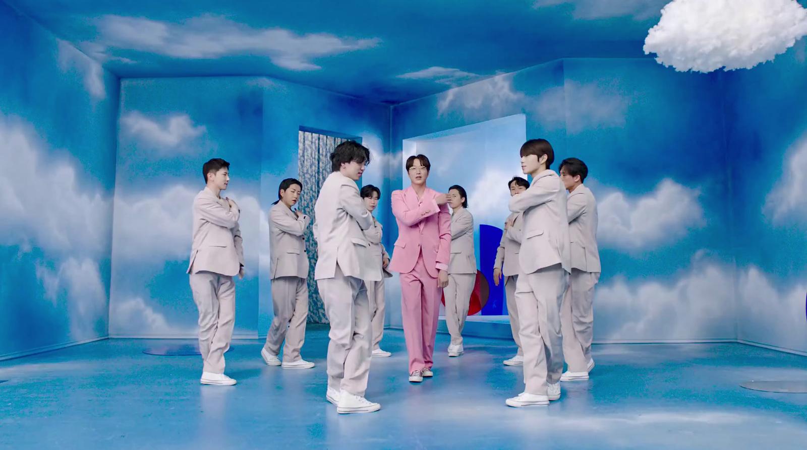 a group of men in suits standing in a room