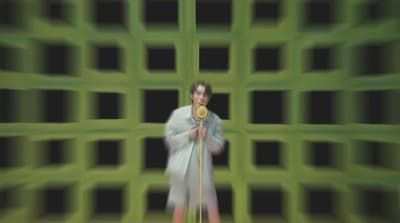 a blurry photo of a woman holding a gold medal