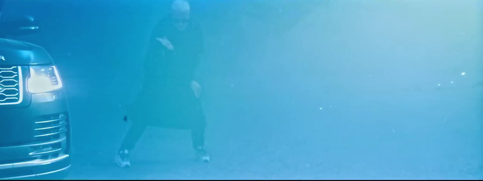 a woman standing next to a parked car under water