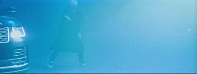 a woman standing next to a parked car under water