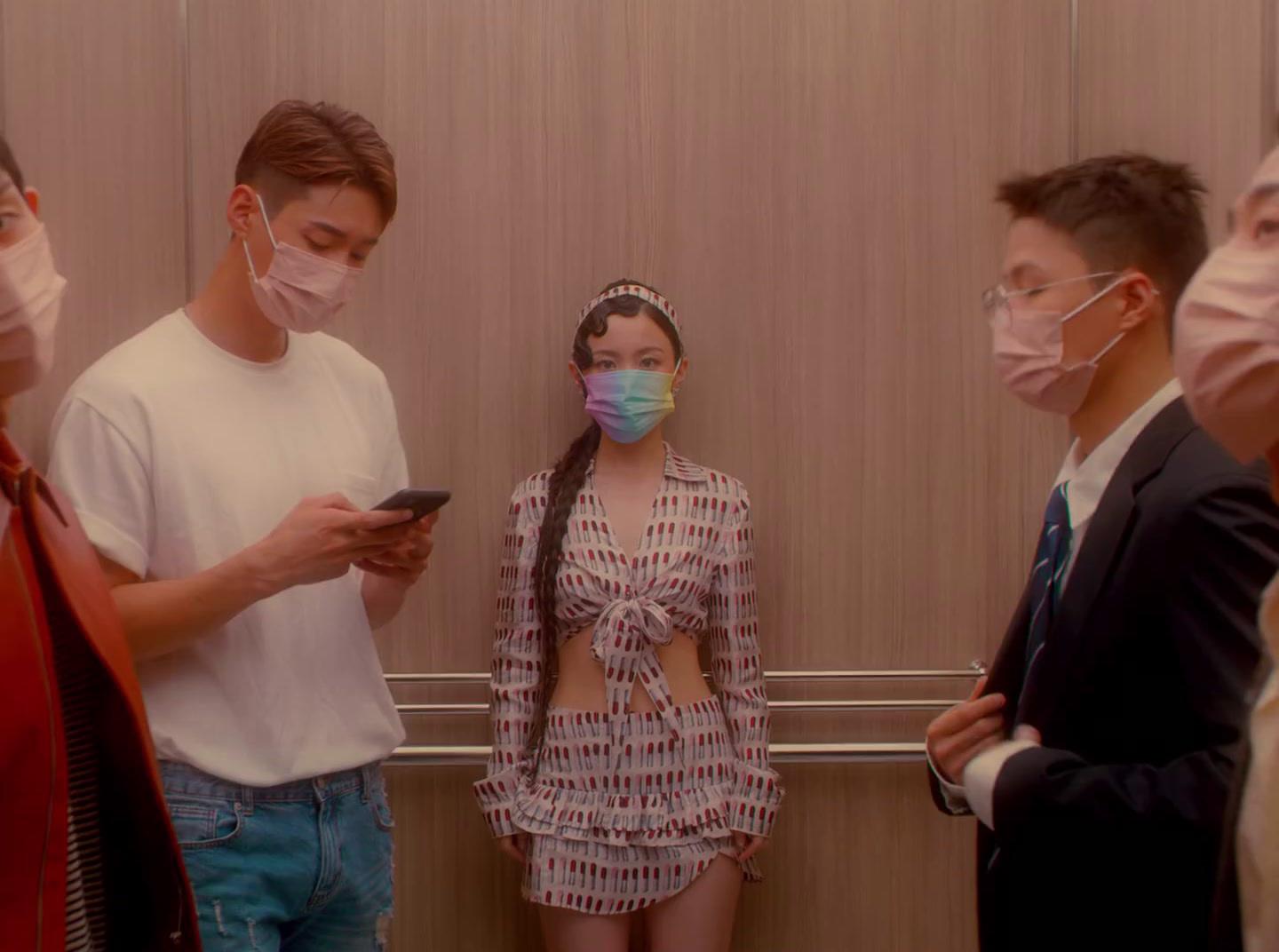 a group of people standing around each other wearing face masks