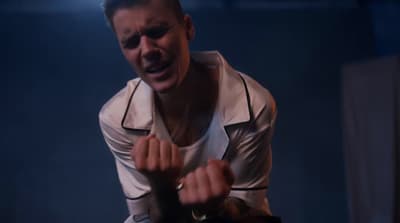 a man with his hands in the air