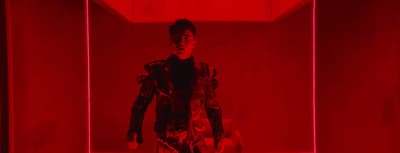 a man standing in a room with a red light
