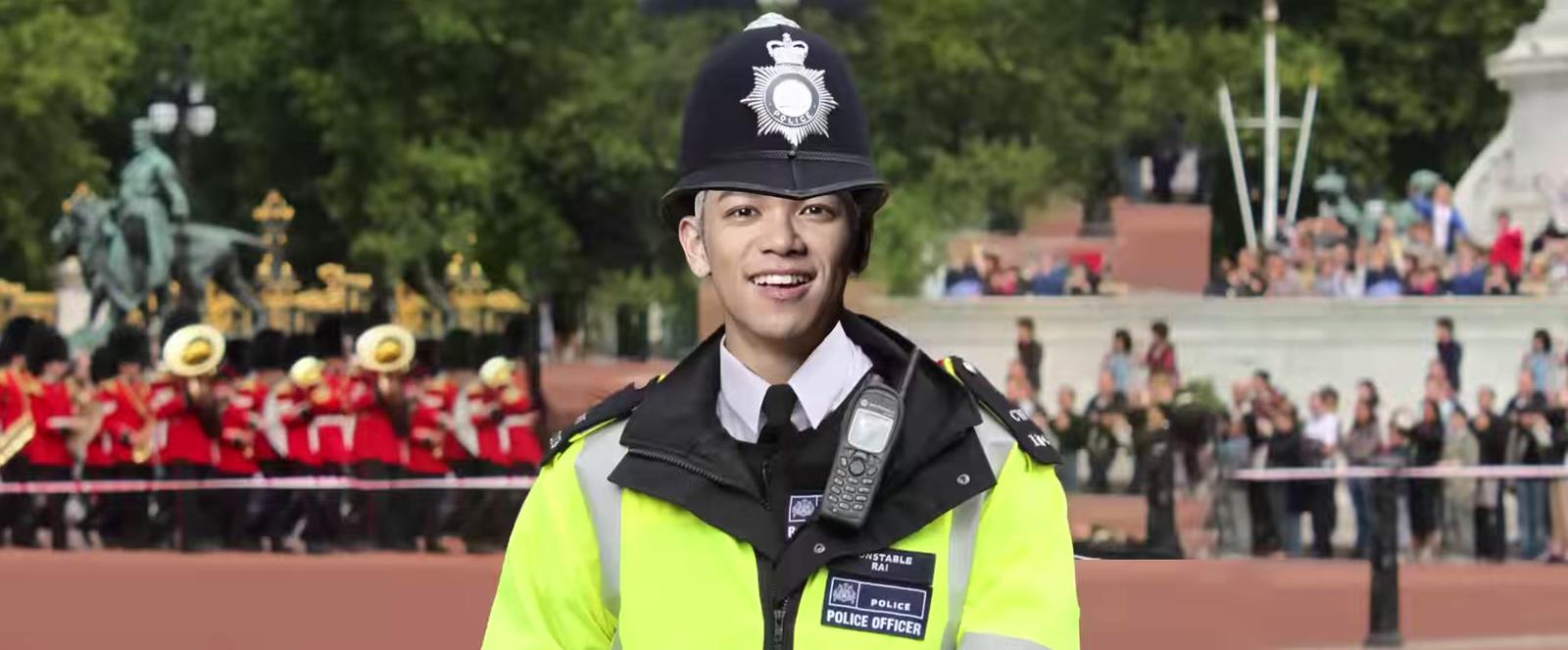 a man in a police uniform standing in front of a crowd