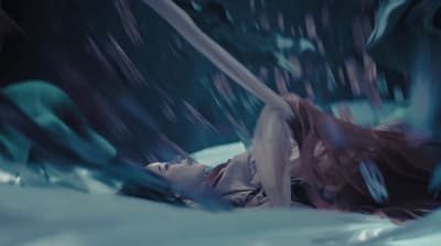 a woman laying on top of a bed covered in snow
