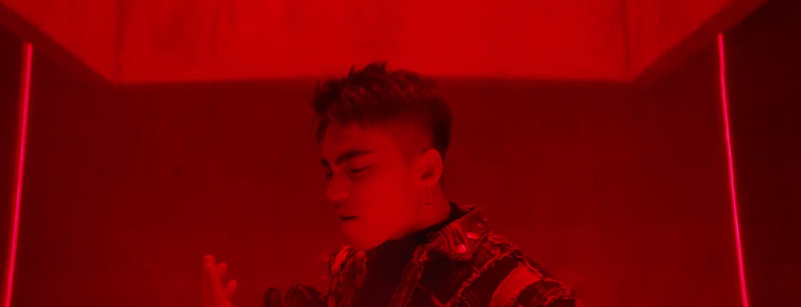 a man standing in front of a red light
