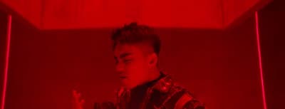 a man standing in front of a red light