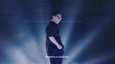a man standing in front of a blue light