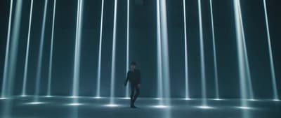 a man standing in front of a wall of lights