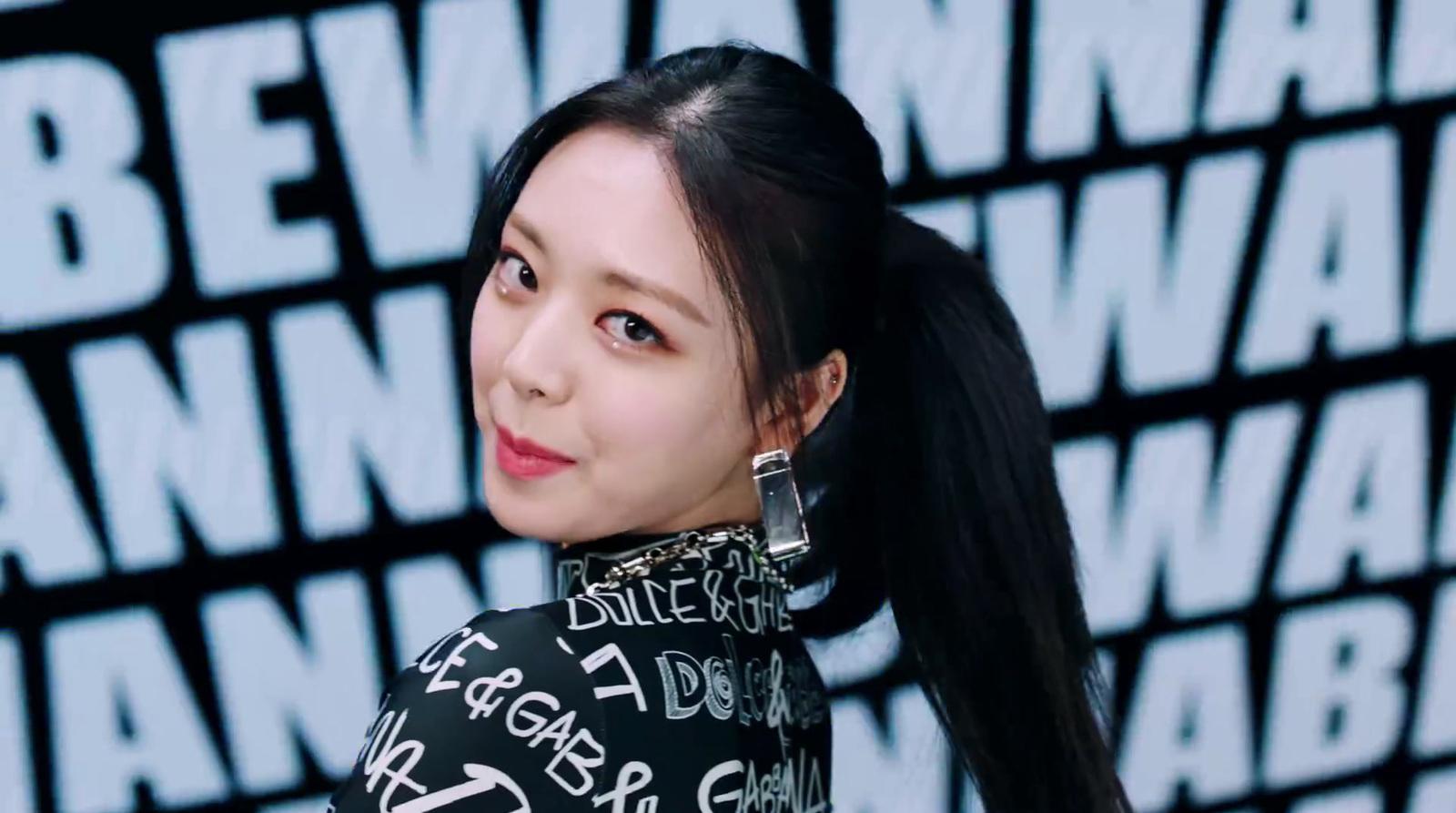 a woman with long black hair wearing a black shirt