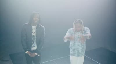 a man and a woman standing in a dark room