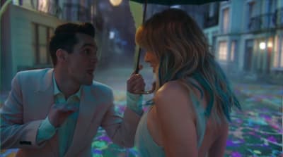 a man and a woman standing under an umbrella