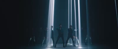 a group of people standing in a dark room