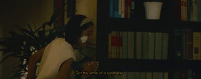 a woman standing in front of a book shelf