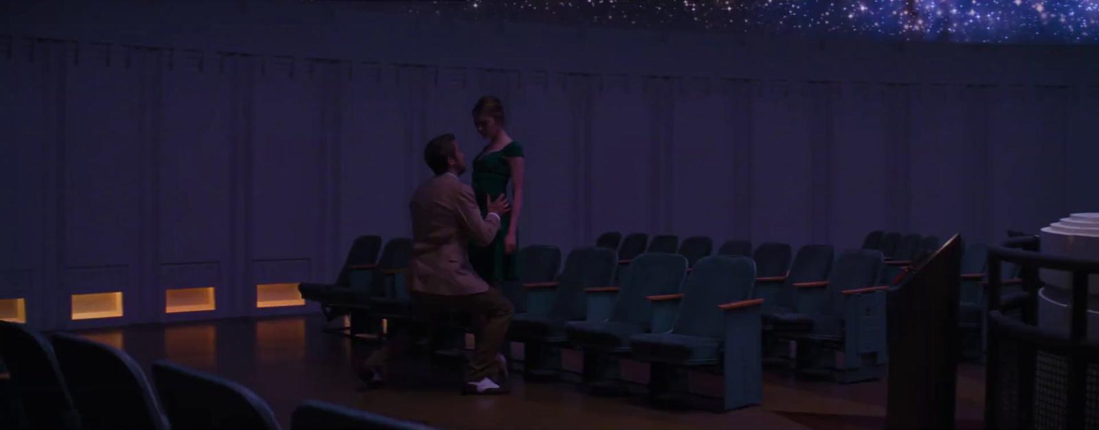 a man and a woman standing in front of a stage