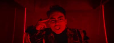 a man in a dark room with a red light