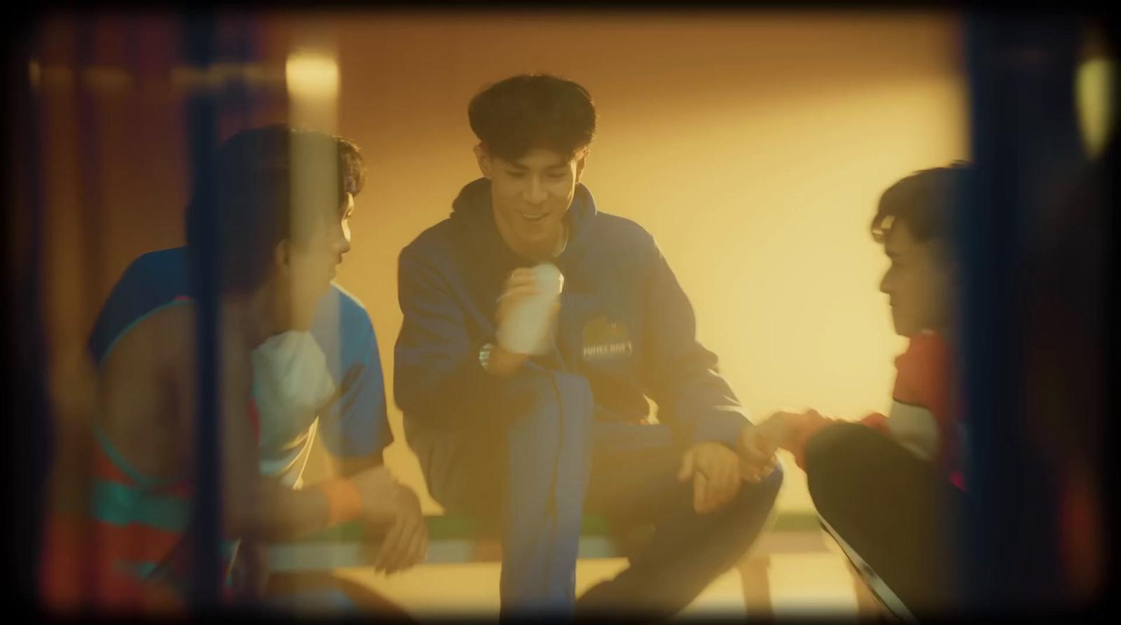 a group of young men sitting next to each other