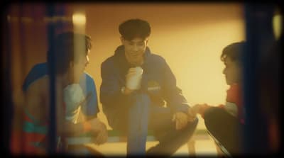 a group of young men sitting next to each other