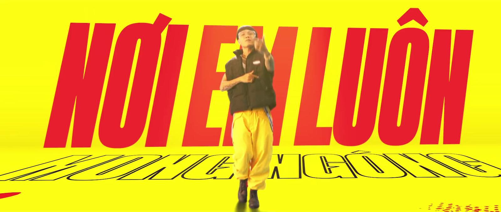 a man standing in front of a yellow background