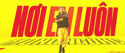 a man standing in front of a yellow background