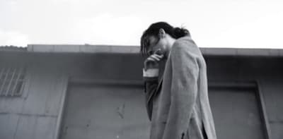 a woman in a coat talking on a cell phone
