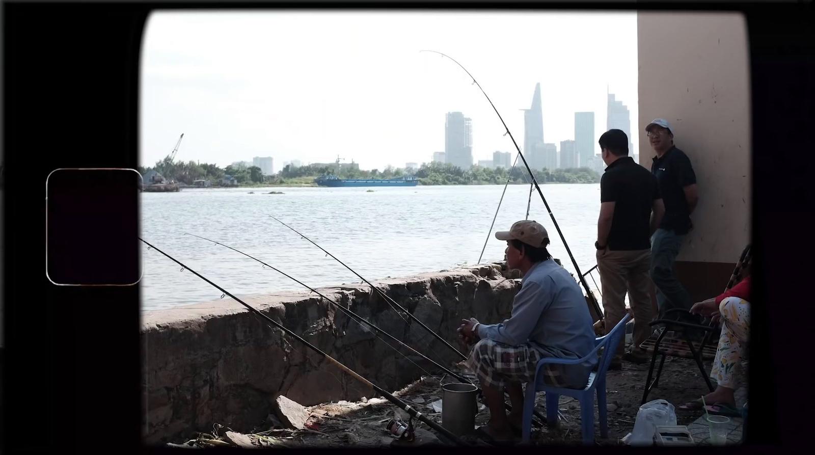 a group of men standing next to a body of water