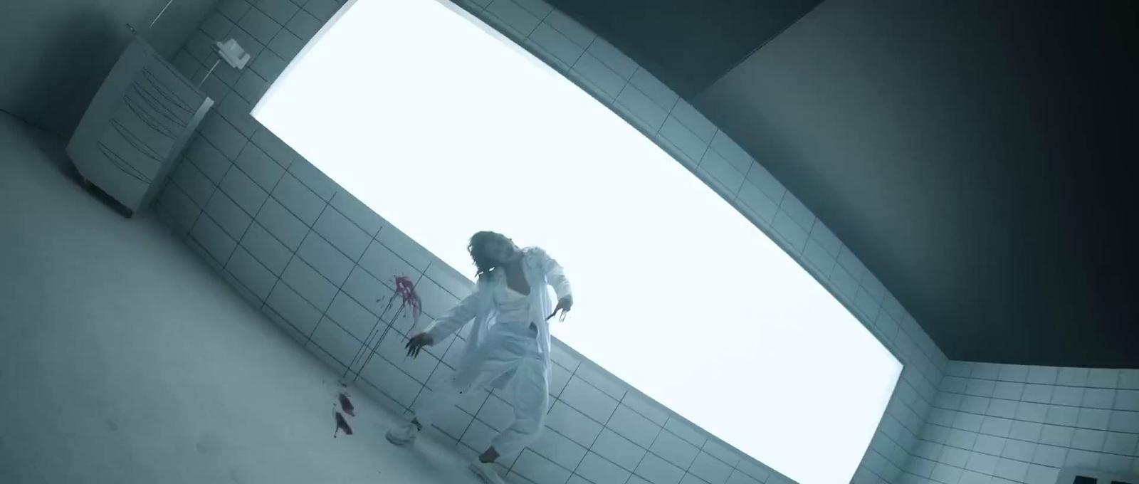 a woman in a white dress standing in a bathroom